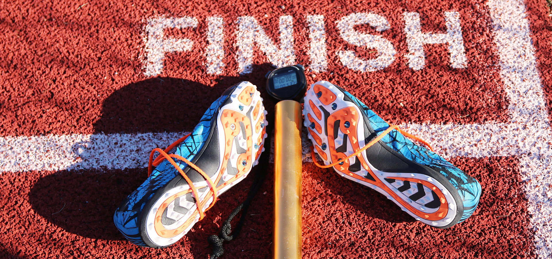 Running shoes and baton at finish line.