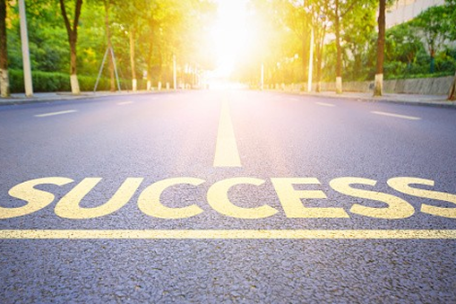 Road with "SUCCESS" leading into sunlight.