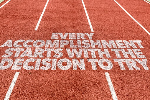 Motivational quote on a running track.